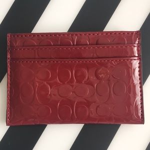 Coach red credit card holder.